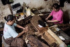 Workers prepare tobacco leaves to roll them into cigars at the Rizona Baru factory in Temanggung, Central Java. JP/Agung Parameswara

