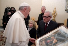 Girl meets pope and promptly steals his hat