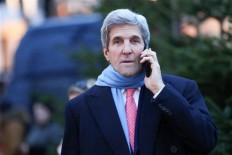 US Secretary of State, John Kerry, uses his mobile phone in Hamburg, Germany, Wednesday Dec. 7, 2016. 