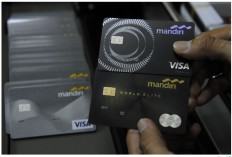Plastic money: An employer supervises the printing of Bank Mandiri credit cards at the state-owned lender's headquarters in Jakarta in 2016.