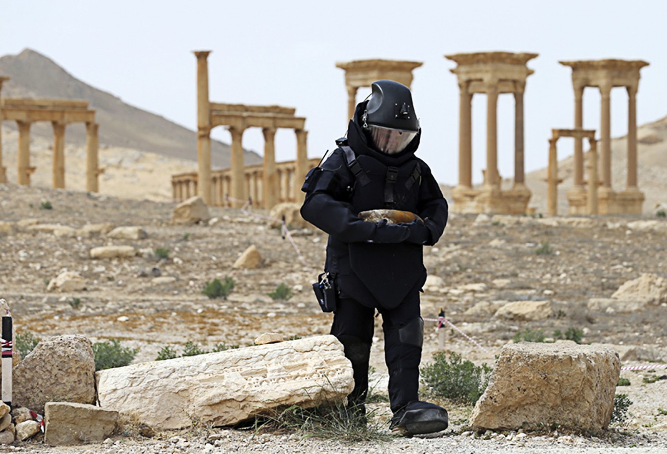 Security checks -- In this April 8, 2016 file photo provided by Russian Defense Ministry press service, a Russian deminer checks for mines in the Palmyra ancient ruins, Syria. Palmyra, the archaeological gem that Islamic State fighters retook Sunday from Syrian troops, is a desert oasis surrounded by palm trees, and a UNESCO world heritage site, that boasts 2,000-year-old towering Roman-era colonnades and priceless artifacts. It is also a strategic crossroads linking the Syrian capital, Damascus, with the country's east and neighboring Iraq.