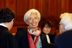 IMF board: Lagarde will remain as chief despite conviction 