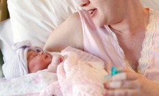 A mother holds her newborn baby at a hospital in Corpus Christi, Texas, US, in November 2011. 