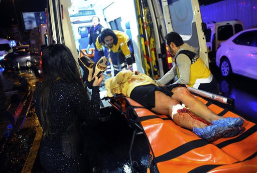 Fatal attack: Medics carry a wounded person at the scene after an attack at a popular nightclub in Istanbul, early Sunday, Jan. 1, 2017. Istanbul Governor Vasip Sahin said that an armed assailant has opened fire at a nightclub in Istanbul during New Year's celebrations. Turkish authorities have banned distribution of images relating to the Istanbul attack within Turkey.(IHA via AP)