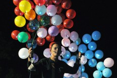 A man carries balloons for New Year Eve’s celebrations at Sumberwatu, Prambanan, Yogyakarta, on Saturday night. JP/ Magnus Hendratmo