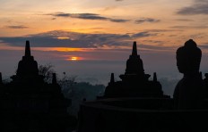 Thousands of people watch the first sunrise of 2017 appear at the peak of Borobudur temple in Central Java on Sunday morning. JP/Tarko Sudiarno