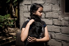 Close to her heart beat: Agung Dewi Laina Pertini, 12, hugs her dog, Salem, in Bangki Lasan Mas village, Ubud, Gianyar, Bali. Gung Dewi got the dog two years ago when she was sick. They have not been parted since then. JP/ Agung Parameswara