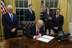 On first day, Trump signs health care executive order 