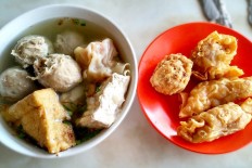 Queuing for a bowl of hot 'bakwan Malang' in East Jakarta