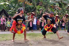 Two children perform a dance during the parade of Kebo Ketan in Sekarputih village, Widodaren, Ngawi, East Java. JP/Magnus Hendratmo