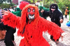 Two men wearing “Dong” and “Krek” costumes perform the Dongkrek dance to chase evil spirits away in Sekarputih village, Widodaren, Ngawi, East Java during the Kebo Ketan festival. JP/ Magnus Hendratmo