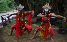 Two Malangan mask dancers perform at the opening of Gebyar Budaya Malangan mask ritual at Mbah Karimun grave, Pakisaji, Malang, East Java in December. Mbah Karimun is known as the maestro of Malangan dance. JP/ Aman Rochman