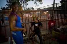 In this Jan. 24, 2017 photo, Olympic silver medalist Emilio Correa Jr., left, mentors female boxer Legnis Cala, center, at a sports center in Havana, Cuba. "They can bring more glory to the Cuban sport," Correa said. "They are diamonds in the rough. The motor skills, the explosive nature and the energy of Cuban boxers are also present in these women." AP/Ramon Espinosa