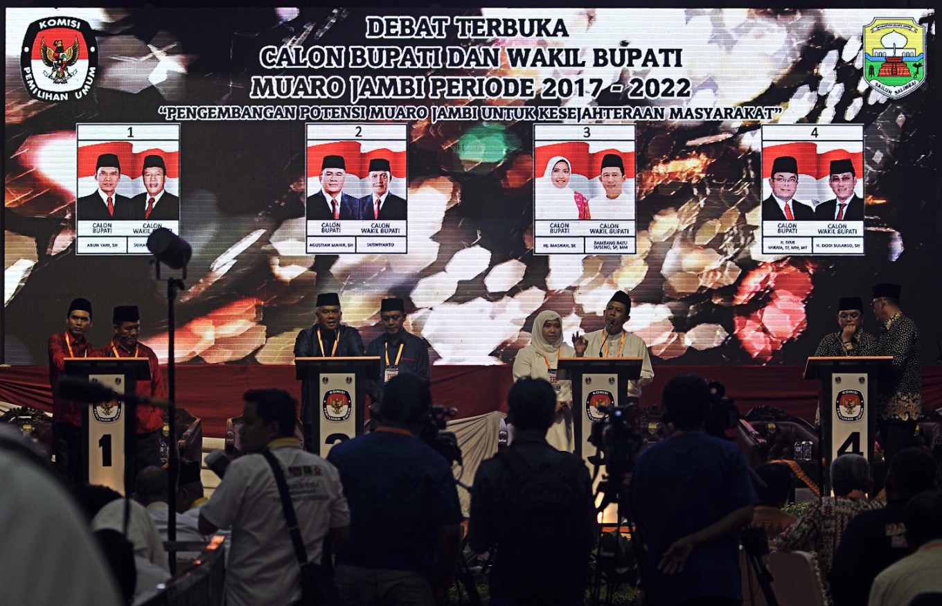 Four pairs of regent and deputy regent candidates for the upcoming Muaro Jambi regency election, namely Abun Yani-Suharyanto (left), Agustian Mahir-Suswiyanto (second left), Masnah-Bambang Bayu Suseno (second right) and Ivan Wirata-Dodi Sularso (right), attend a candidate debate in Muaro Jambi, Jambi, on Jan. 16.
