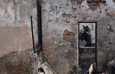 A resident of Kramat Dalam, Kwitang clean their house after fire razed their home in Central Jakarta on Feb. 8, 2017. 