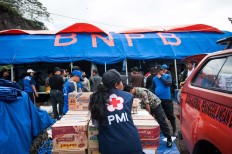 An Indonesian Red Cross worker stands in front of a National Disaster Mitigation Agency (BNPB) rescue post in Songan village, Kintamani, on Monday, February 13, 2017. JP/ Anggara Mahendra
