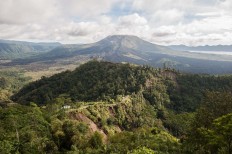 An aerial view of Mount Batur and the main road to Payang village, Kinatamani, Bali, which was struck by a landslide last week. Landslides also occurred in other villages, such as Bantas, Tabu, Yeh Mampeh, Culali, Tukad and Alengkong, captured from the top on Monday, February 13, 2017. JP/ Anggara Mahendra