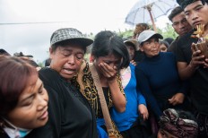 A woman cries during a burial in Songan village on Monday, February 13, 2017. JP/ Anggara Mahendra
