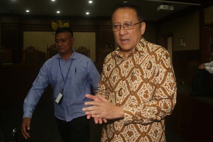 Former Regional Representatives Council (DPD) speaker Irman Gusman talks to reporters after hearing the judge's verdict against him at the Jakarta Corruption Court in Jakarta on Feb. 20, 2017.