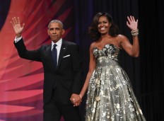 This Sept. 17, 2016 file photo shows President Barack Obama and first lady Michelle Obama at the Congressional Black Caucus Foundation's 46th Annual Legislative Conference Phoenix Awards Dinner in Washington. The former president and first lady have signed with Penguin Random House, the publisher announced Tuesday, Feb. 28, 2017. 
