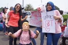 Participants of Women's March pose with their posters during a rally in front of the Presidential Palace in this file photo on March 4, 2017.