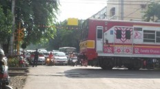 Listening to music, motorist grazed by passing train in North Jakarta