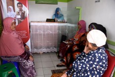 Residents queue for drugs to be distributed during a healthcare program in the Indonesia Medika Clinic Malang, East Java, on Tuesday (21/2). JP/ Aman Rochman