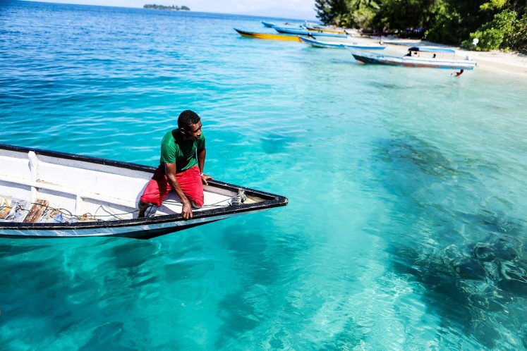 See-through sea: A fisherman tries to reach the shore of one of the Fam Islands.