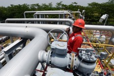 A technician checks a pipeline valve at the onshore receiving facility (ORF) of state-owned natural gas company PT Pertamina Gas in Porong, Sidoarjo, East Java.