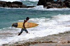 Riding the waves at Wediombo Beach, Yogyakarta
