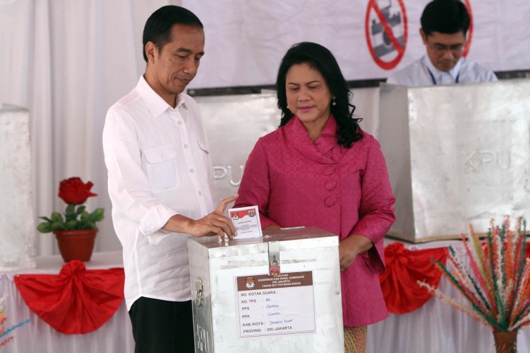 President Jokowi and First Lady Iriana vote in the April 19, 2017, Jakarta regional election at a polling station in Gambir, Central Jakarta.