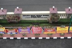Flowers from Ahok supporters arrive at police headquarters
