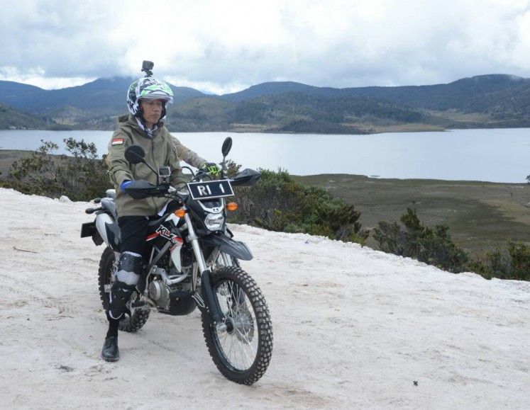 President Joko “Jokowi” Widodo gets ready to inspect the progress of trans-Papua road project by trail motorbike in Wamena on May 10. 