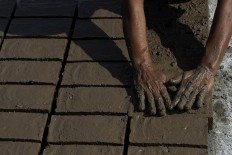 A woman makes bricks in Trowulan, Mojokerto, East Java. Women are responsible for fashioning the brick molds. JP/Sigit Pamungkas