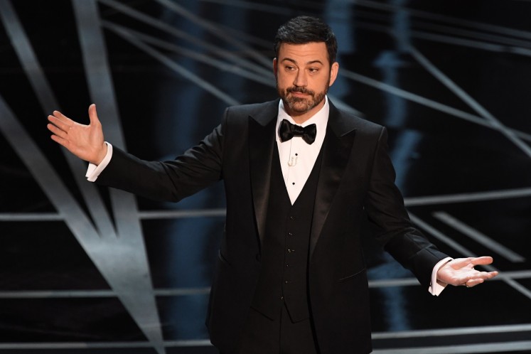This file photo taken on February 26, 2017 shows Host Jimmy Kimmel on stage at the 89th Oscars in Hollywood, California. Late night funnyman Jimmy Kimmel will return to host the Oscars, the Academy said May 16, 2017, as the glitzy annual show moves on from the biggest mix-up in its history. The 49-year-old comedian will be reunited with producers Michael De Luca and Jennifer Todd for the 90th Academy Awards, which will take place on March 4, 2018.