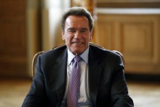 Schwarzenegger says you can have four Hummers and still save planet 