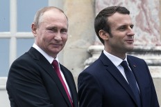 Closer ties: French President Emmanuel Macron (right) and his Russian counterpart President Vladimir Putin visit an exhibition about Russian emperor Peter the Great at the Grand Trianon following their meeting at the Versailles Palace, near Paris, on May 29. Macron hosts Russian counterpart Vladimir Putin in their first meeting since he came to office with differences on Ukraine and Syria clearly visible.
 