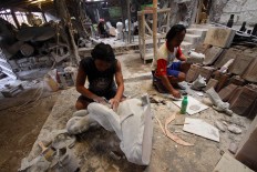 Workers finish sculptures after the molding process at Patuk, Gunungkidul, Yogyakarta on Feb. 21. JP/Aditya Sagita