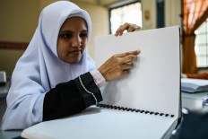 Blind Malaysian Muslims study Quran using Braille