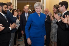 Defiant May vows to lead Britain to Brexit after UK election blow