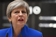 British PM defies critics and vows to govern