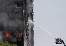 At least 12 dead in London tower block fire: police