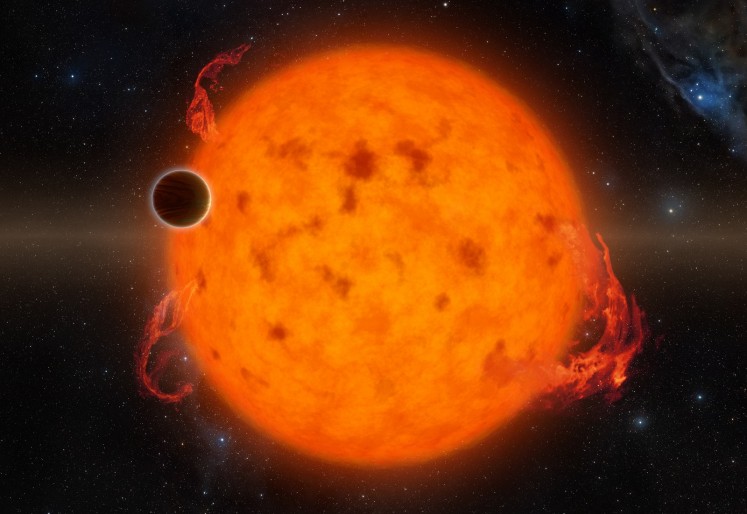 This handout illustration obtained courtesy of NASA/JPL-Caltech shows the K2-33, one of the youngest exoplanets detected to date. It makes a complete orbit around its star in about five days. Astronomers announced June 20, 2016 the discovery of the youngest planet ever found outside our solar system, lending new insight into how planetary systems form. 