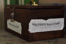 An infaq (charity) donation box. JP/Magnus Hendratmo