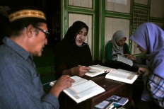 Shinta Ratri, 55, the leader of Al Fatah Islamic boarding school, recites verse Al Hud 71-88 of the Quran. There are 46 transgender students in the boarding school but only 26 students are active during the Ramadhan fasting month. JP/Magnus Hendratmo