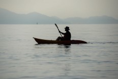 Rustono is paddling his canoe at the Biwako Lake. JP/Tarko Sudiarno
