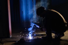 Rustono welds an iron to build his new factory. JP/Tarko Sudiarno