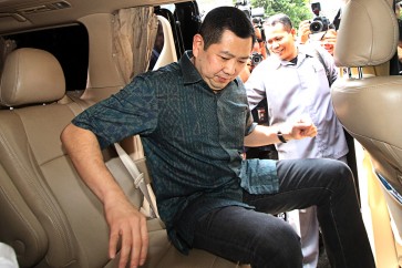 MNC Group owner Hary Tanoesoedibjo (right) enters his vehicle after he attended a questioning at the Cybercrime Directorate at the National Police’s Criminal Investigation Division in Jakarta on June 12. 