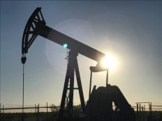 An oil rig drills a well at sunrise, owned by Parsley Energy Inc. near Midland, Texas, on May 3.