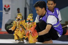 A participant prepares his robots for the traditional dance category during the competition. JP/Arya Dipa